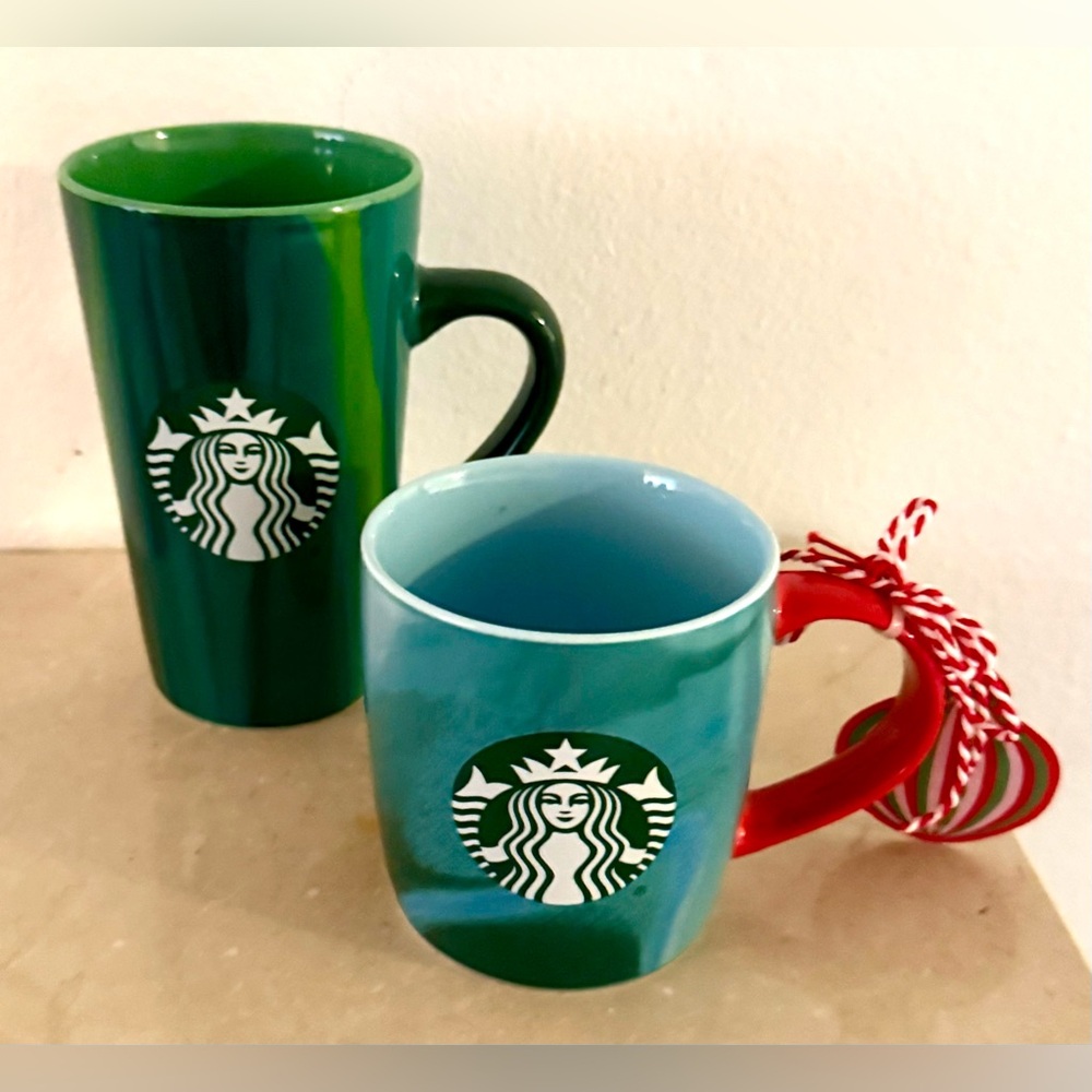 2 Starbucks mugs. Blue, & Green. Tall on is 16oz and the short mug is 11 oz.